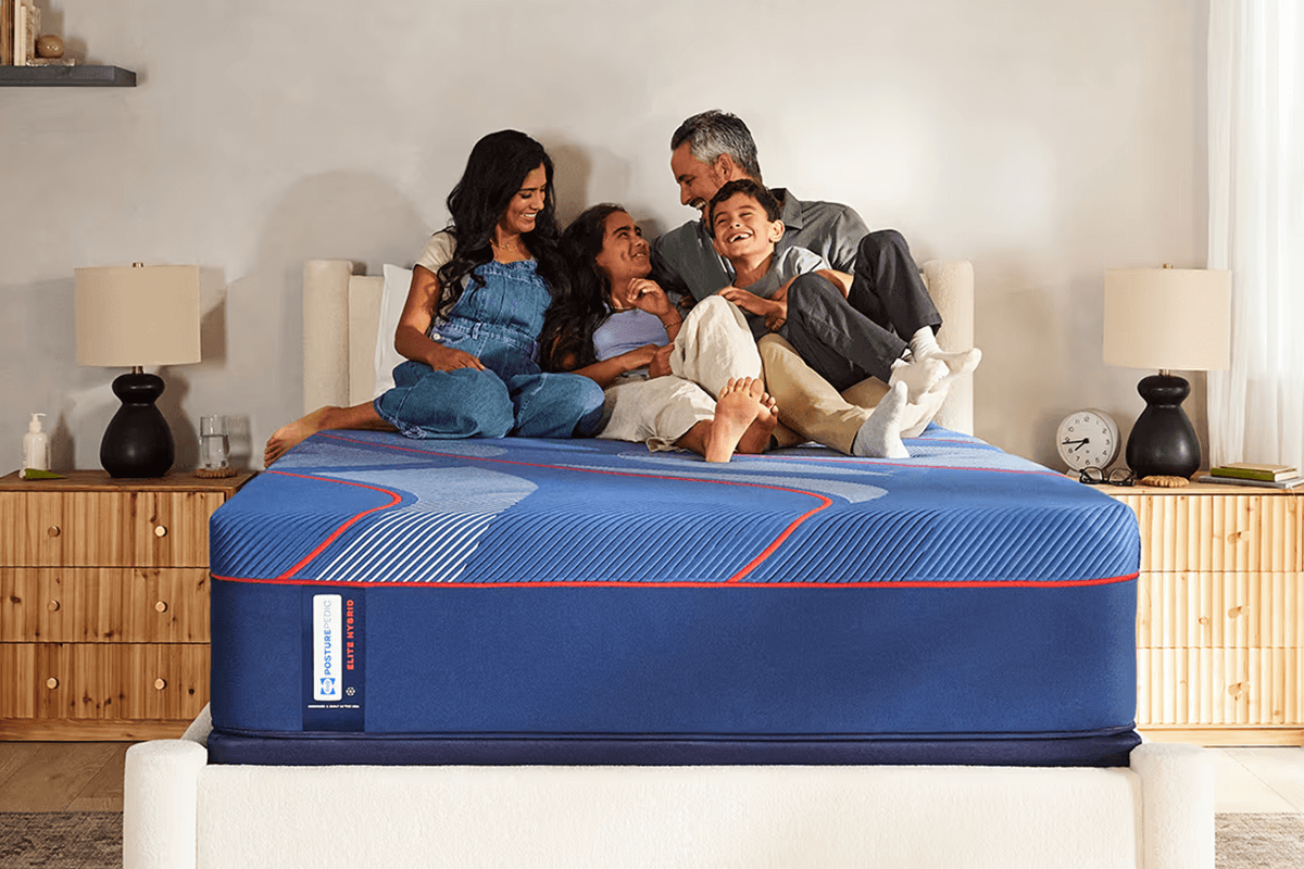family of four hanging out on a mattress