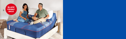 couple on a Posturepedic Elite with a red badge and white text saying, Black Friday Sale