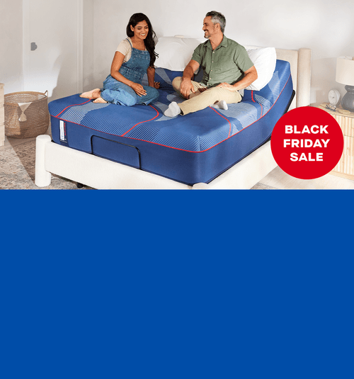 couple on a Posturepedic Elite with a red badge and white text saying, Black Friday Sale