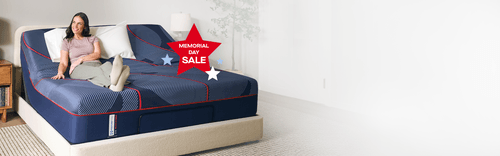 Woman sitting on a Posturepedic mattress