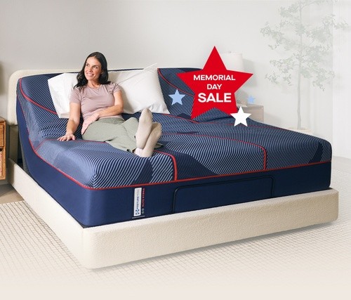 Woman sitting on a Posturepedic mattress