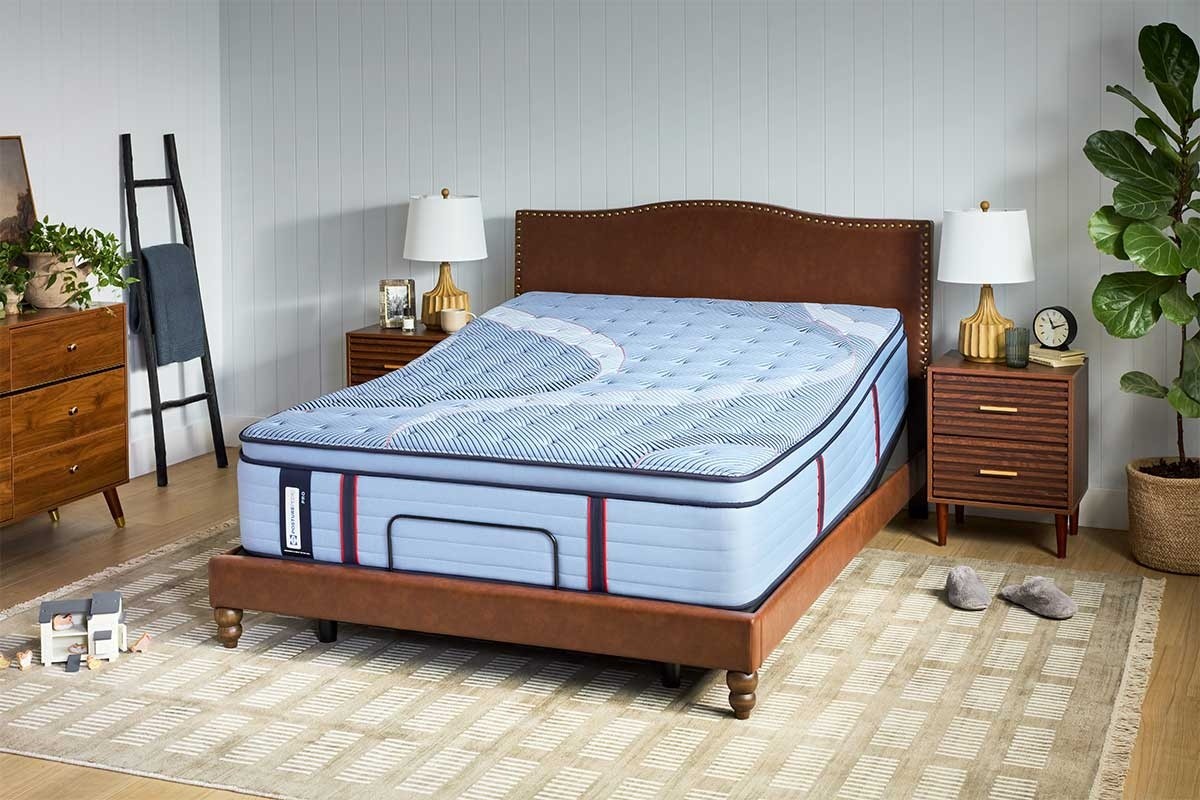 A Posturepedic Pro mattress on an adjustable base in a styled room