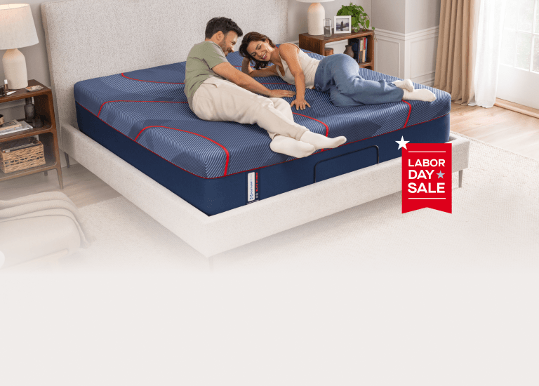 couple on an mattress with a banner that says "labor day sale"