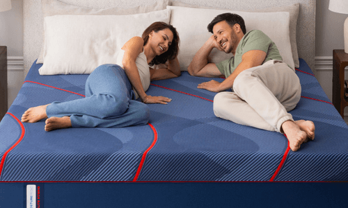 a woman with her golden retreiver relaxing on an Elite mattress model