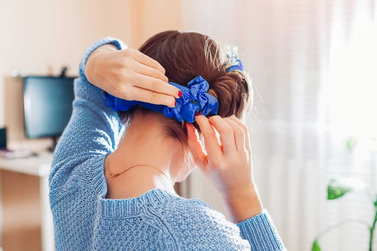 A woman removing heatless curl rollers
