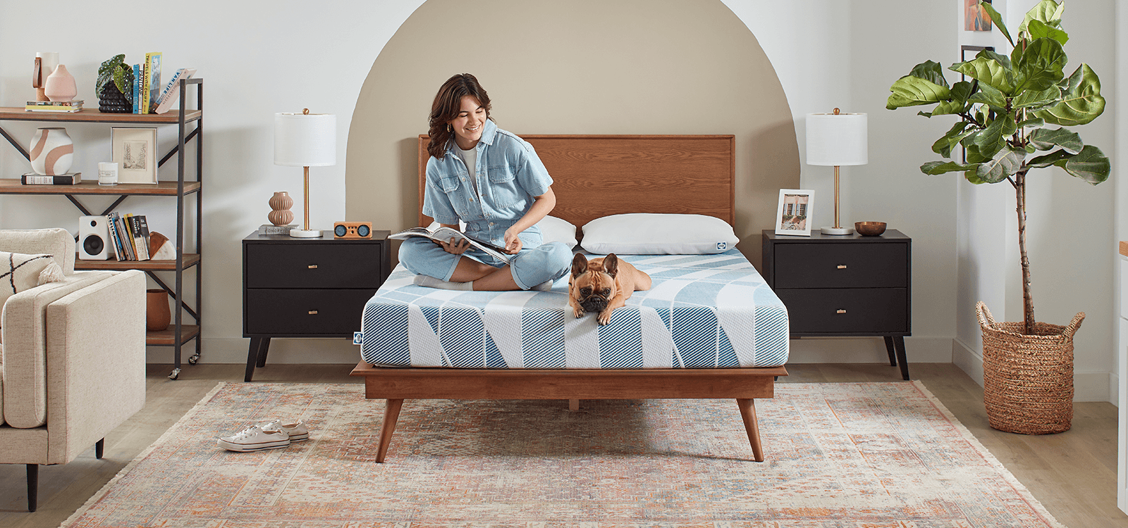 Woman sitting on 8" Dreamlife Mattress with dog